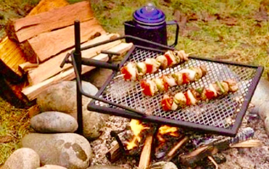 a grill with a bunch of hot dogs on it at Camp Squid Off The Grid in Benzonia