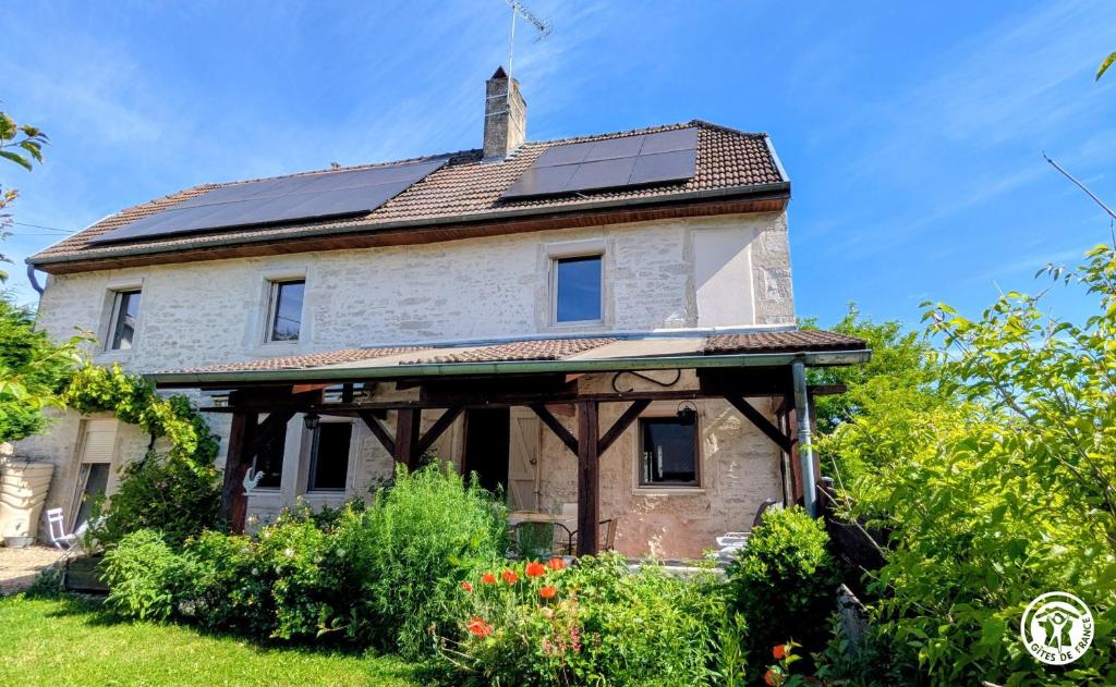 an old house with solar panels on the roof at Le Brocangîte à Jules - 4 pers in Bèze