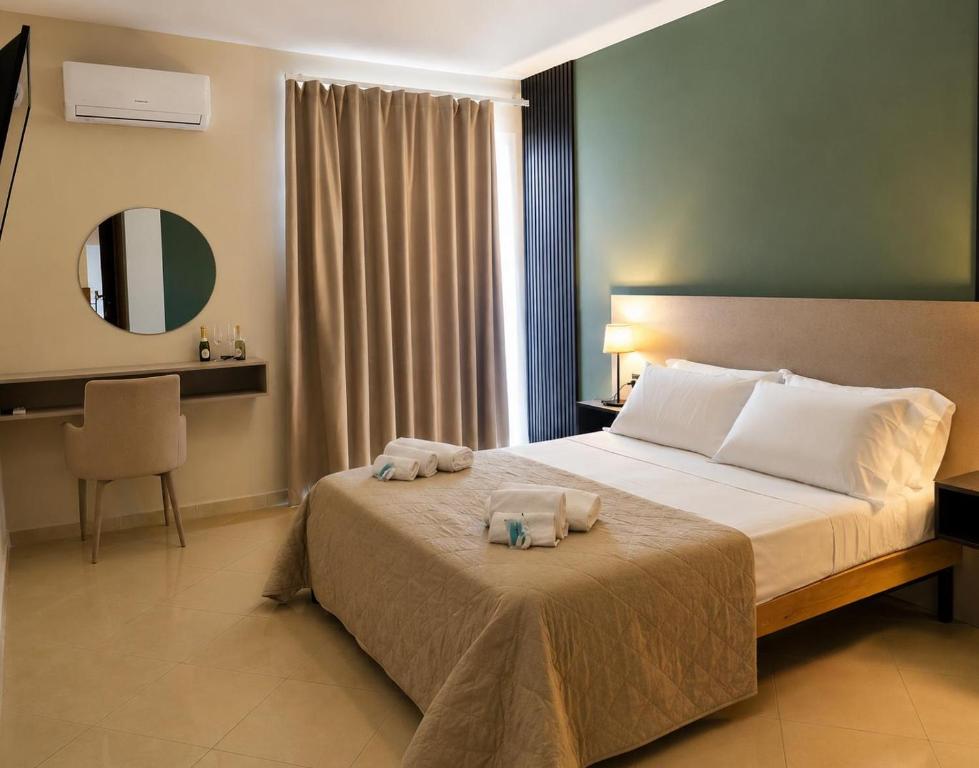 a bedroom with a bed with two towels on it at Hotel Futuro in Aversa