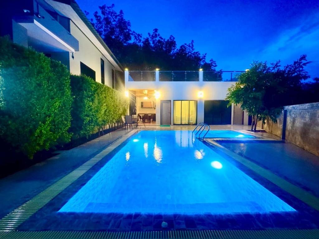 a swimming pool in front of a house at night at Ao Nang Private Rooftop Pool Villa 4BR l 8-10 Guests in Ao Nang 