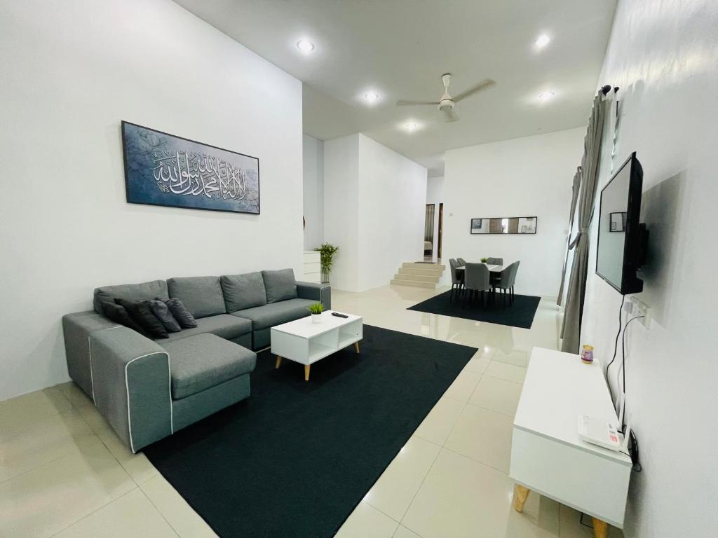 a living room with a couch and a tv at D Azlin Homestay in Kuala Kangsar