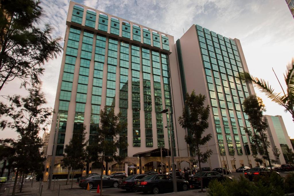 a tall building with cars parked in front of it at Swissotel Lima in Lima