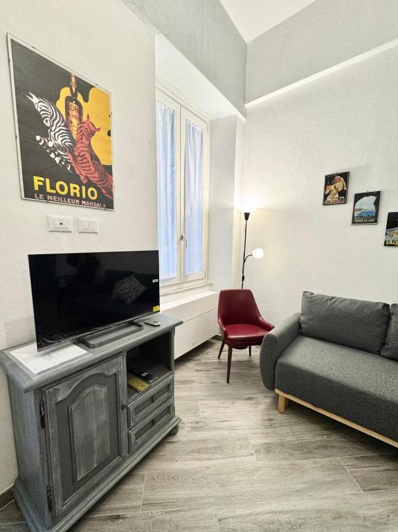a living room with a flat screen tv and a couch at Casa Ferro in Finale Ligure