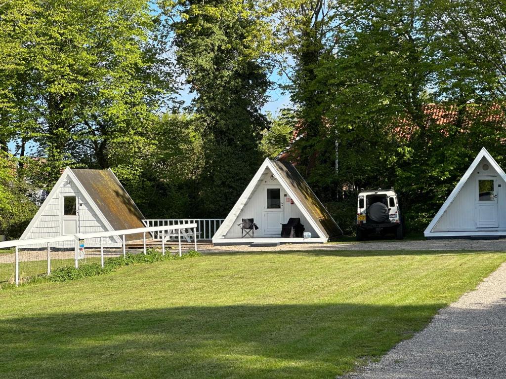 a couple of tents with a dog in the middle at Stege Camping in Stege