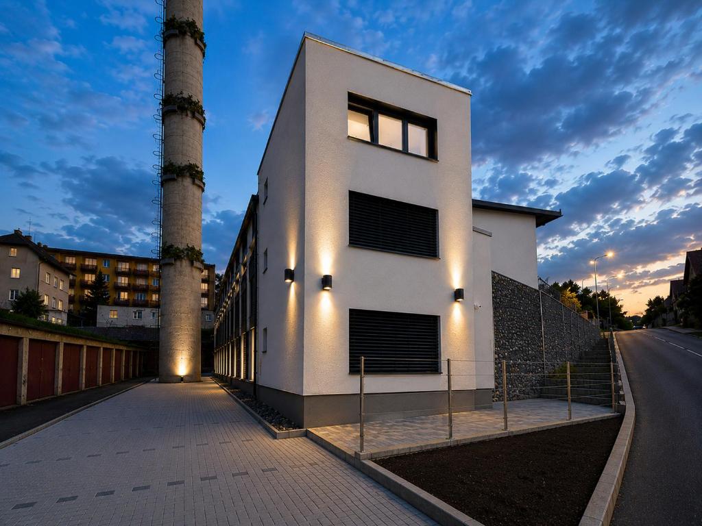 a white building with two palm trees on a street at Microbyty & Apartments in Děčín