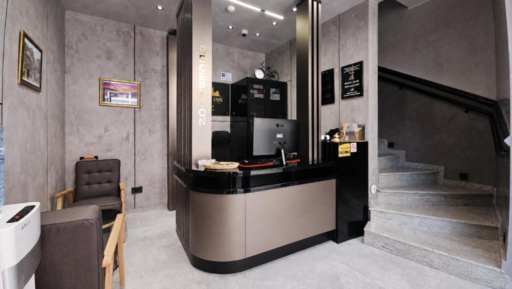 a restaurant with a counter and stairs in a room at Bazaar Inn Boutique & Luxury Rooms in Skopje