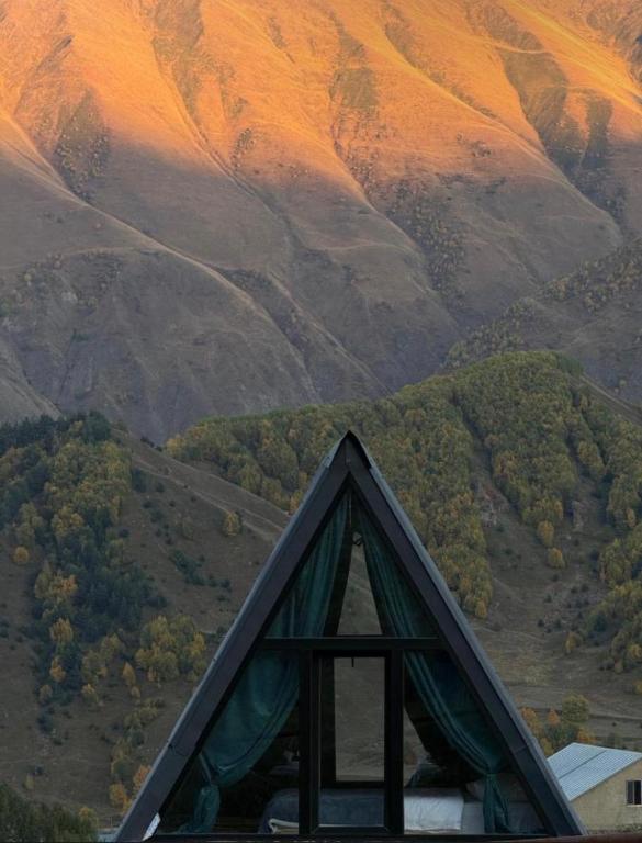 a view of a tent with mountains in the background at Kvirike Cottage Kazbegi in Gorists'ikhe