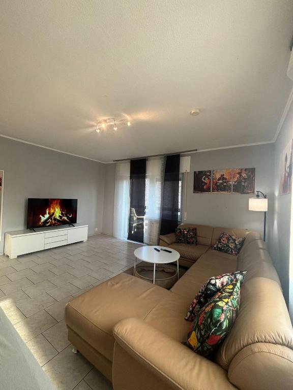 a living room with a couch and a fireplace at Ferienwohnung Habichtweg in Elsdorf