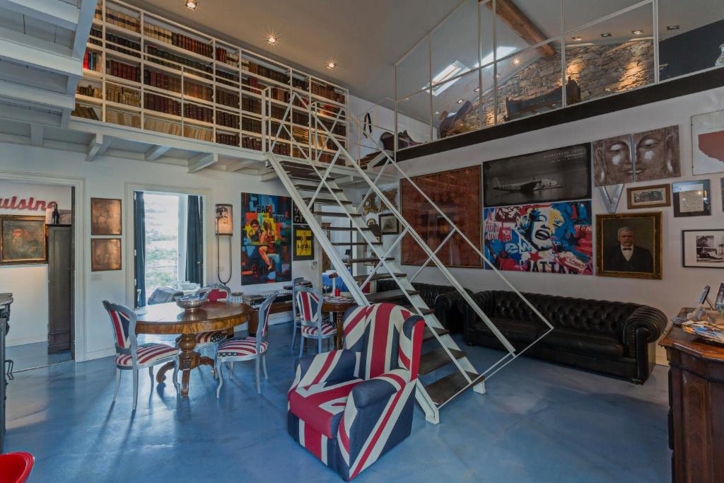 a living room with a spiral staircase and a table and chairs at Loft Garibaldi in Chiavari