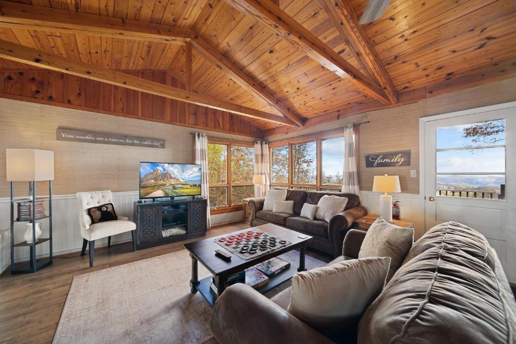 a living room with a couch and a tv at Blowing Rock Skies in Lenoir