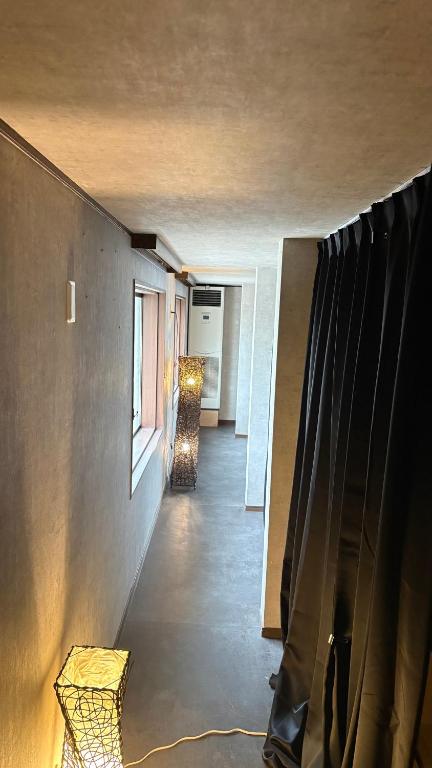 a hallway of a house with a window at ゲストハウスヤドカリ in Nanao