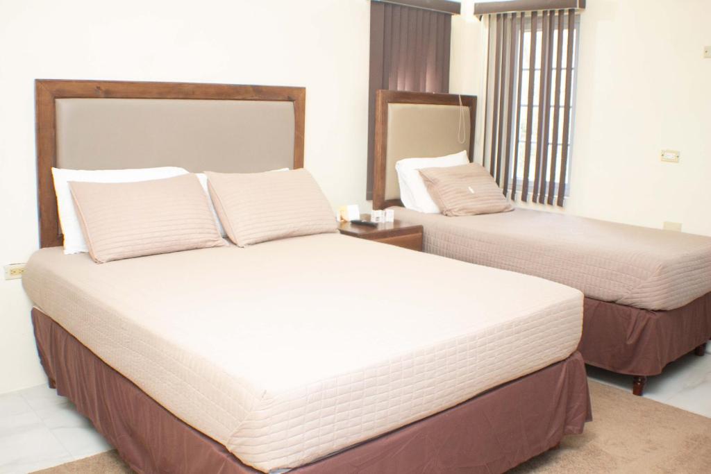 a hotel room with two beds in a room at The Vista Inn Studio #3 in Falmouth