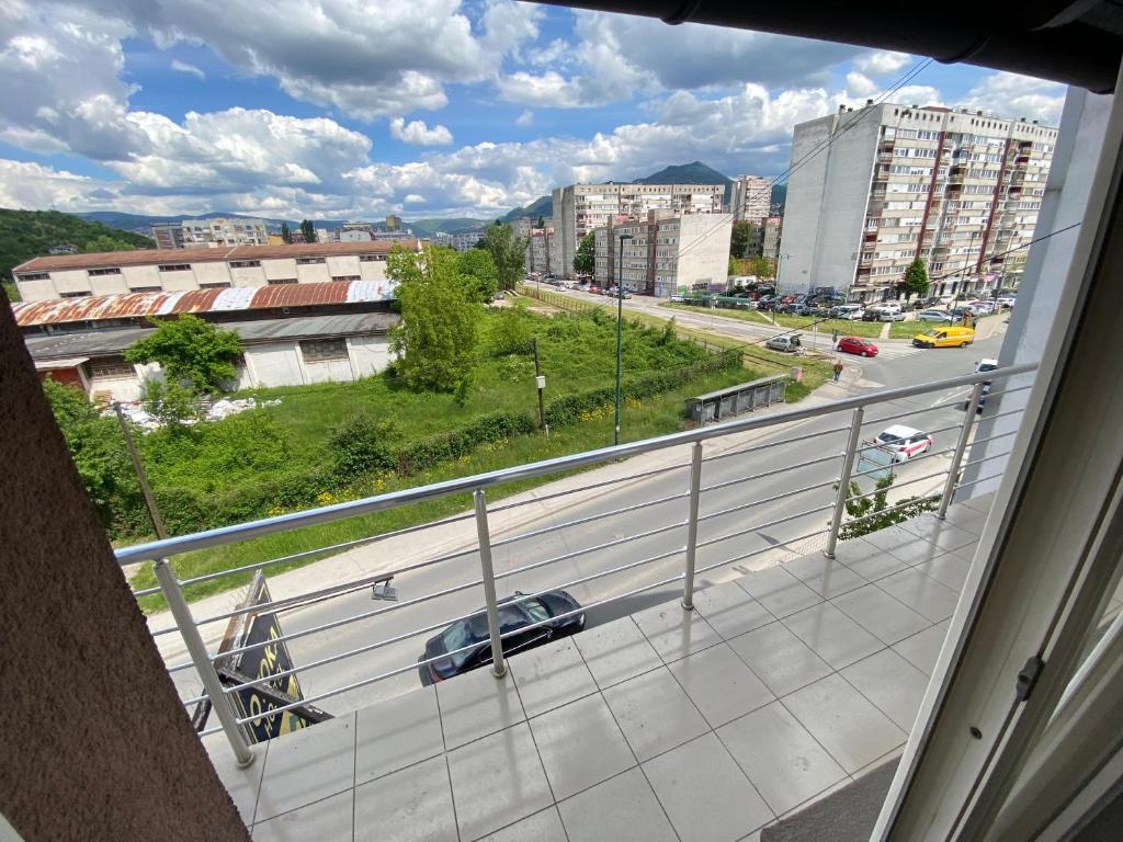 a balcony with a view of a road and buildings at Otoka Hostel in Sarajevo
