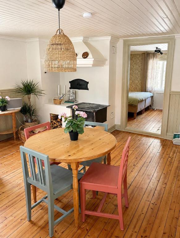 a dining room with a wooden table and chairs at HomeSweetSweden in Malung