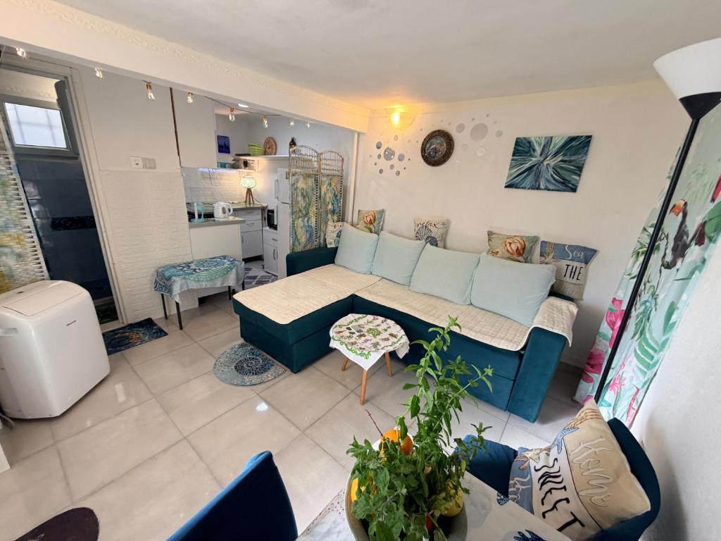 a living room with a couch and a table at Laniakea small apartment in the house in Risan in Risan
