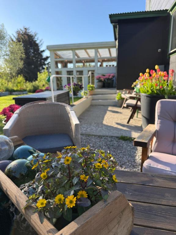 a garden with chairs and flowers in a wooden table at Valberg Gjestegård in Valberg
