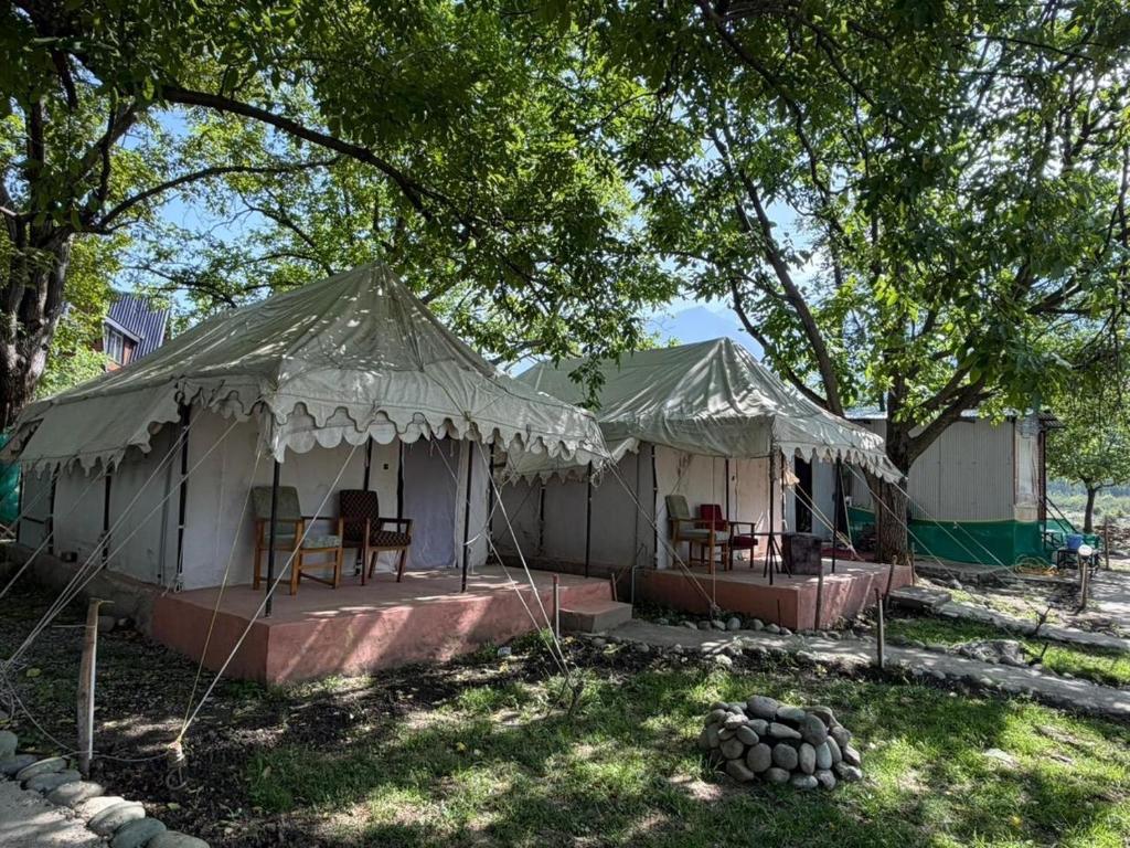a white tent with tables and chairs in it at starry nights stay in Batakūt