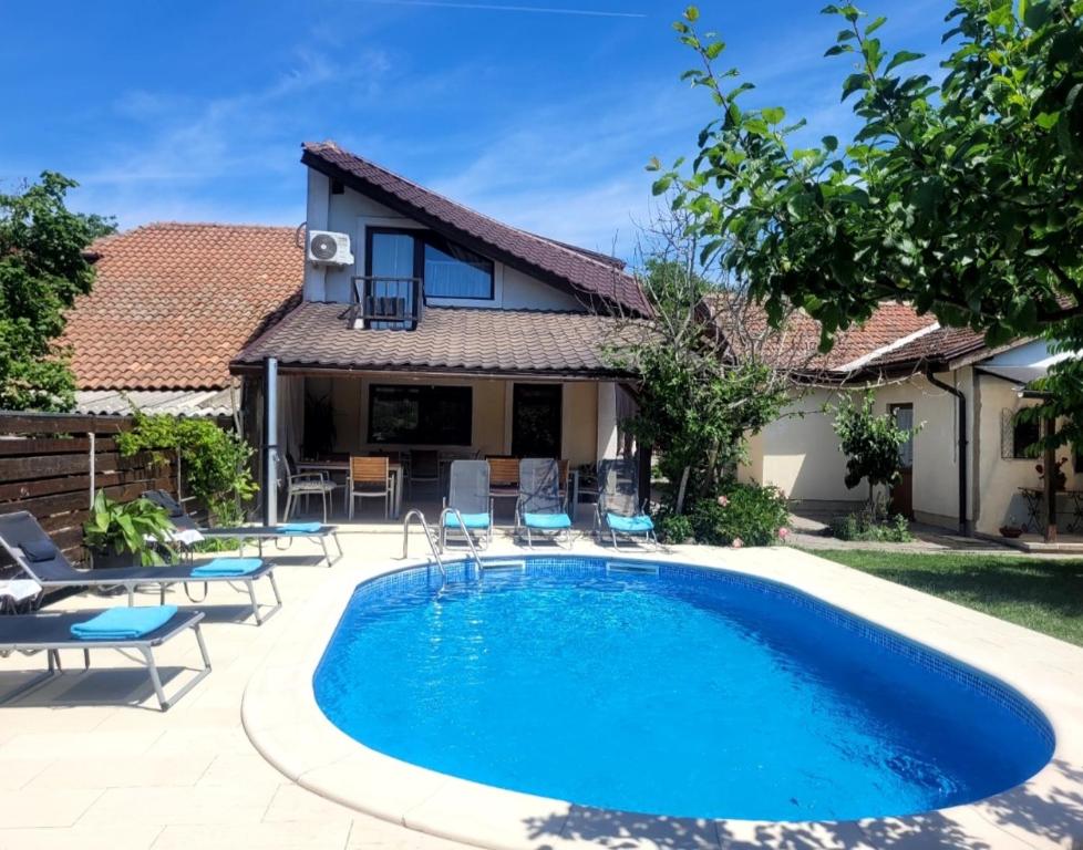a swimming pool in front of a house at LA CASSA in Timişoara