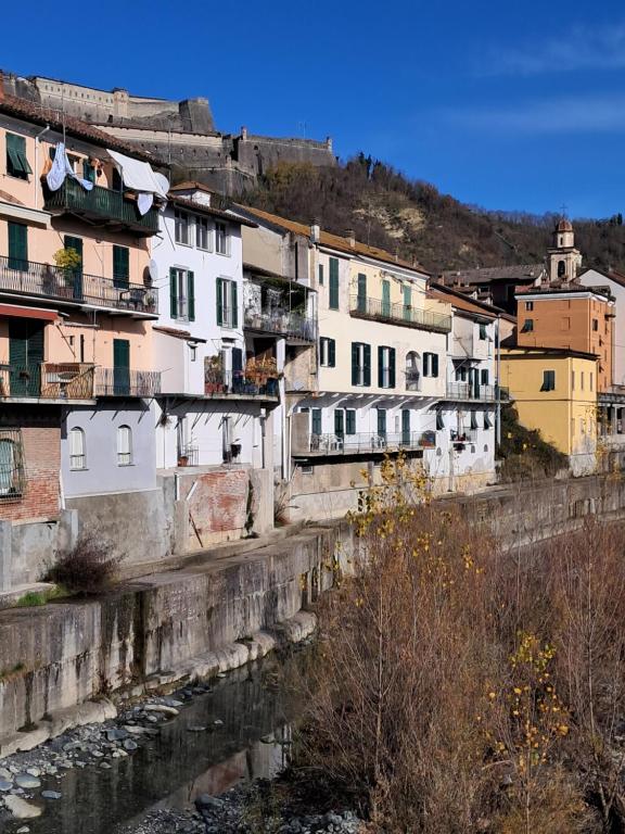 a group of buildings next to a river at B&B Giù di sotto in Gavi