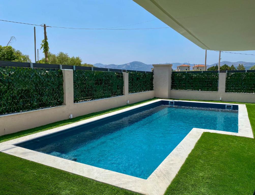 a swimming pool in the backyard of a house at Vei Estate in Schinias
