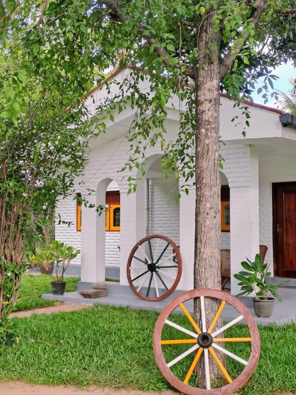 a woodenoked wagon wheel in front of a house at Claasz Prime Lagoon in Katunayaka