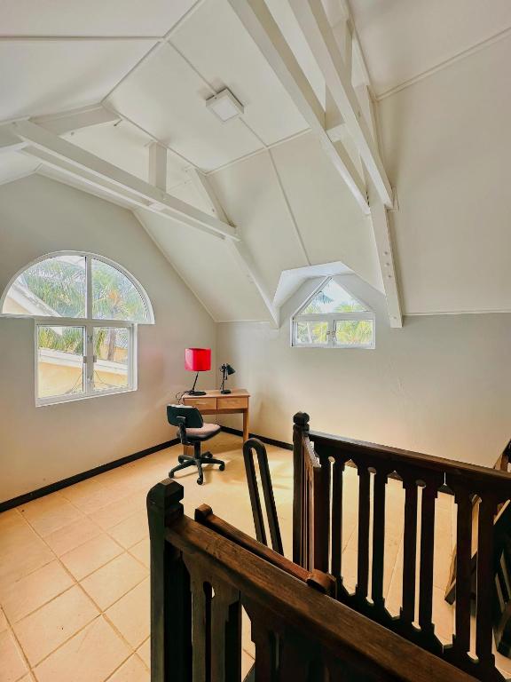 an attic room with a desk and a chair at 11 Residence Thalassa in Belle Mare
