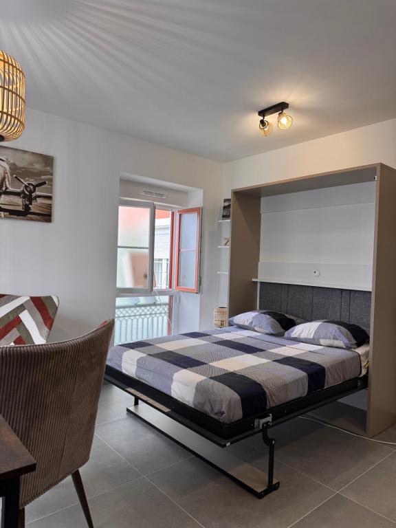 a bedroom with a large bed and a table at 105 - Voiron centre - DeTassigny in Voiron