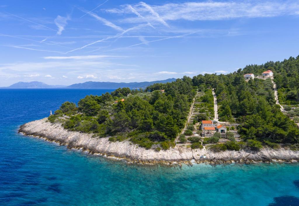 an island in the water with a house on it at Villa Insula by Belmont Realty in Vela Luka