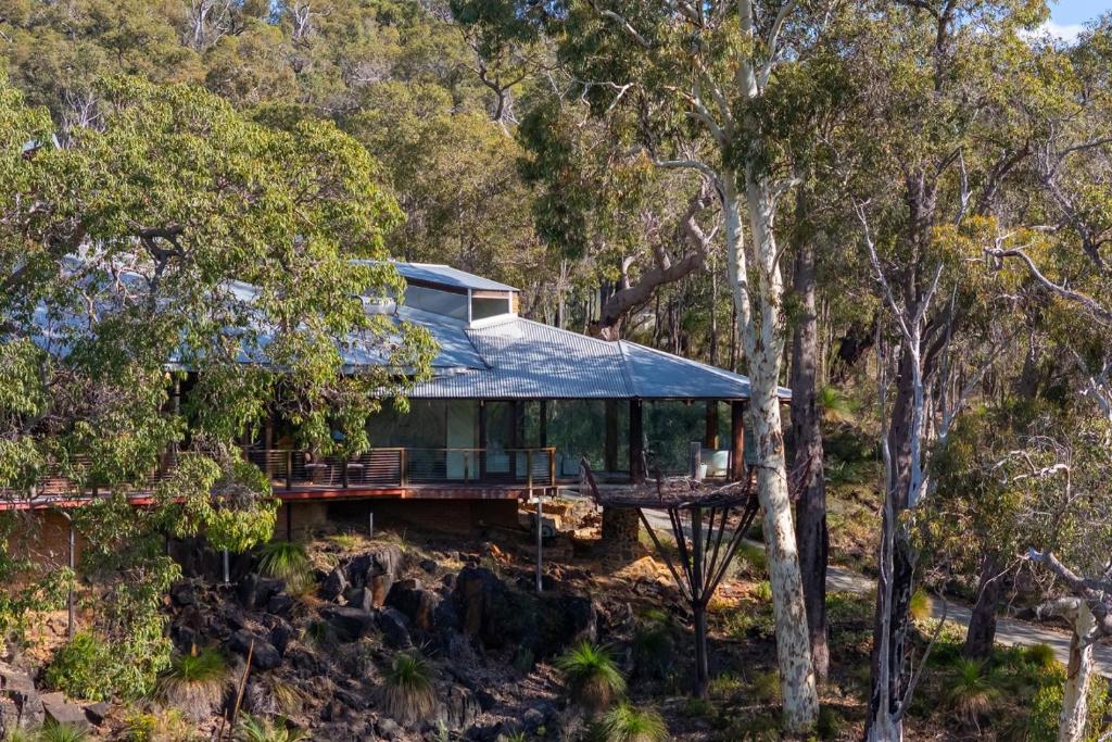 a house in the middle of the forest at The Hills Opera House in Bickley