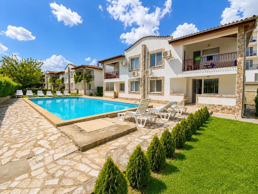 a villa with a swimming pool in a yard at Complex Sea & Sky next to the Beach ! in Kranevo