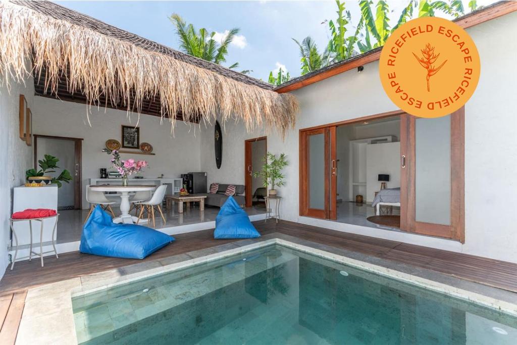 a villa with a swimming pool and a house at NEW Sawah Escape - Tropical 2BR with Pool and Views in Tabanan