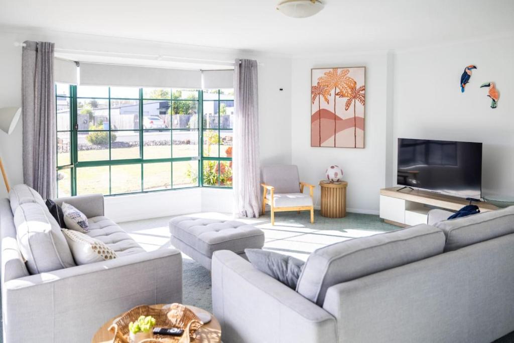 a living room with two couches and a tv at Nautilus Nest - Port Sorell in Port Sorell