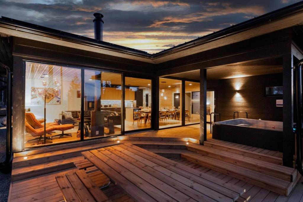a house with a large deck with a bath tub at Stay North - Villa Mono in Pälkäne