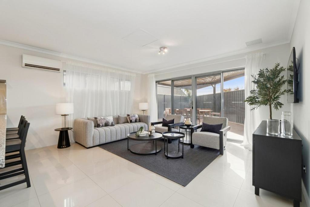 a living room with a couch and a table and chairs at The Grand Aveley House in The Vines