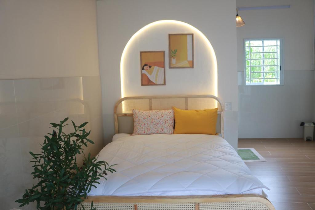 a bedroom with a bed with an arch above it at Tran Phu Riverside House in Can Tho