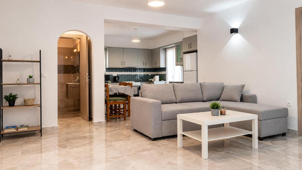 a living room with a couch and a table at Azalea Guesthouse in Andros