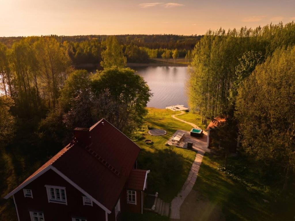 an aerial view of a house next to a lake at Stay North - Mustio in Inkoo