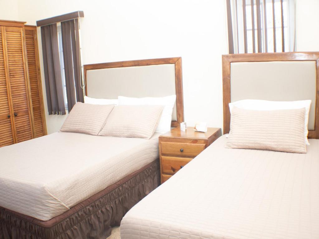 two beds sitting next to each other in a bedroom at The Vista Inn Studio #4 in Falmouth