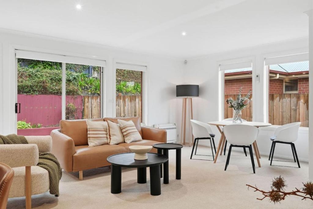 a living room with a couch and a table at Stylish West Hobart Villa in West Hobart