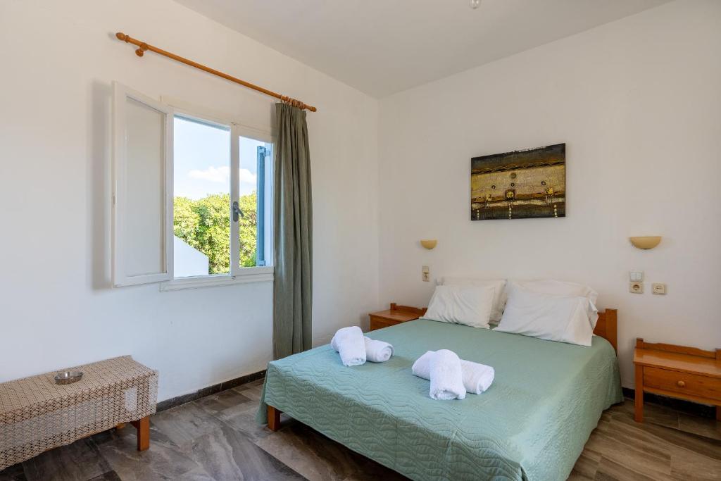 a bedroom with two white towels on a bed at Nautilus Apartments in Sisi