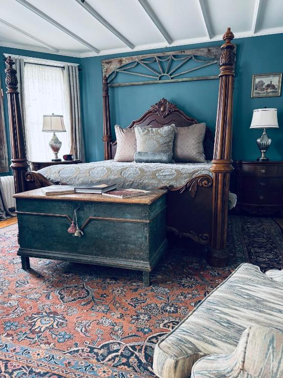 a bedroom with a large bed with a wooden frame at 1000 Islands Bed and Breakfast-The Bulloch House in Gananoque