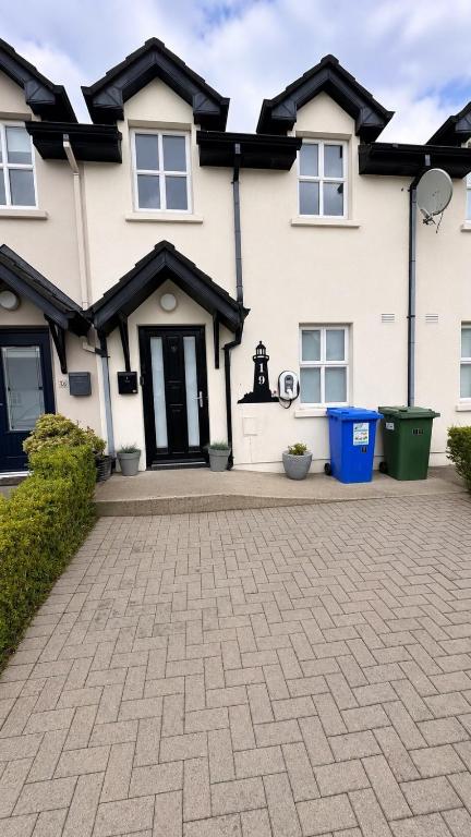 a house with a brick driveway in front of it at Ballyhack by the Sea in Arthurstown
