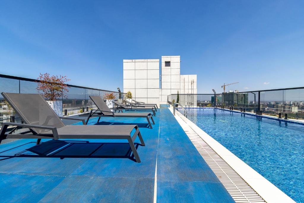 a swimming pool on the roof of a building at Luxury 1 bedroom in Westlands, Rooftop Pool, Next to Kempinski & GTC, Fast Wifi & Pool Table in Nairobi