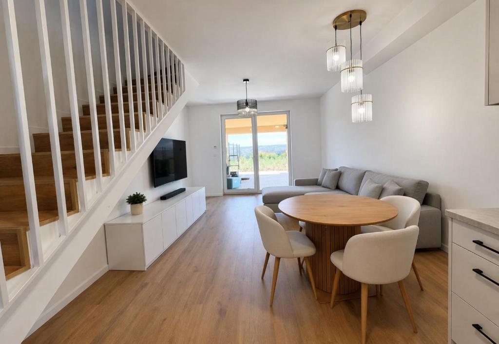 a living room with a table and a couch at Villa La Pollo in Senec