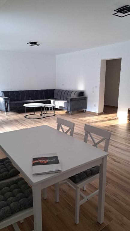 a living room with a white table and a couch at Zen Zone Trio in Foča
