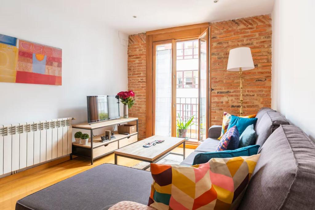 a living room with a couch and a table at Apartamento junto al Ayuntamiento - by wehomes in Santander