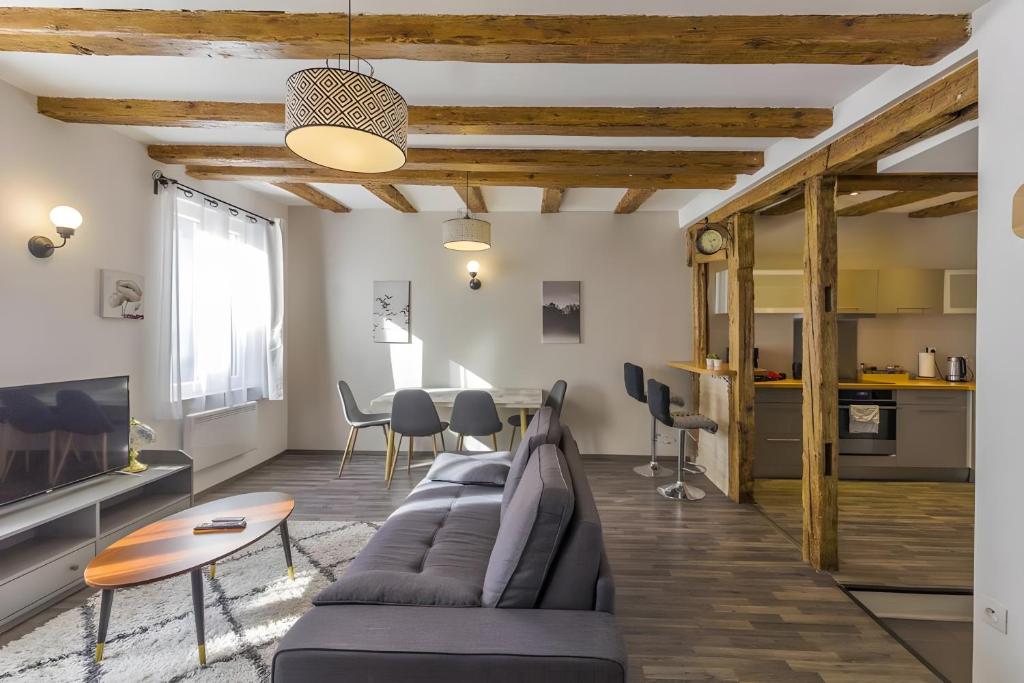 a living room with a couch and a table at La Curiosité in Barr