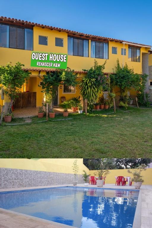 a guest house and a swimming pool in front of a building at Guest House Renascer K&W in Cabo Frio