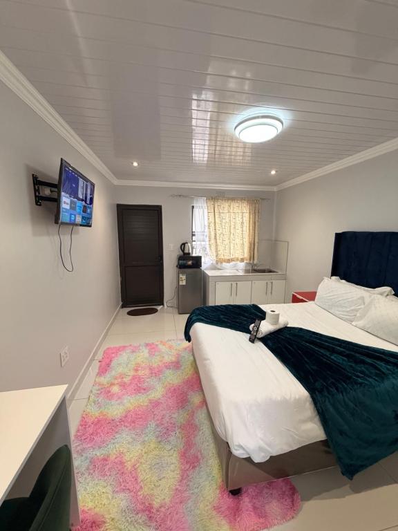 a bedroom with a large bed and a rug at The Perfect Place in Parow