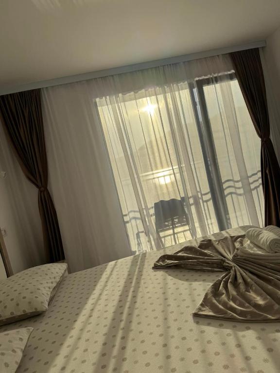 a bedroom with a bed with a large window at CasaA&B in Dubova